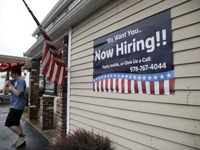 FILE - In this July 24, 2017, file photo, a sign advertising employment hangs outside a restaurant in Middleton, Mass. U.S. businesses added a solid 178,000 jobs in July, a survey found, evidence that employers remain confident enough about future demand to keep hiring. (AP Photo/Elise Amendola, File)