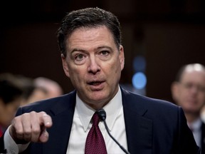 FILE - In this Thursday, June 8, 2017, file photo, former FBI director James Comey speaks during a Senate Intelligence Committee hearing on Capitol Hill, in Washington. Comey has a book deal. Flatiron Books told The Associated Press on Wednesday, Aug. 2, that Comey will write about everything from allegations of ties between Russia and Donald Trump's presidential campaign to the bureau's investigation into Hillary Clinton's use of a private email server. (AP Photo/Andrew Harnik, File)