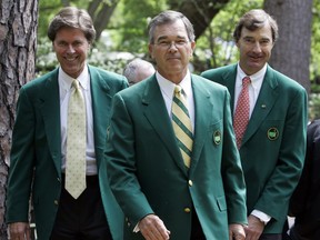 FILE - In this Wednesday, April 4, 2007, file photo, Augusta National Golf Club Chairman Billy Payne, center, arrives with Fred Ridley, left, and Craig Heatley at the media center to brief reporters on the Masters during practice for the 2007 Masters golf tournament at the Augusta National Golf Club in Augusta, Ga. Ridley was been selected to replace Payne as chairman of Augusta National announced Wednesday, Aug. 23, 2017. (AP Photo/Rob Carr, File)