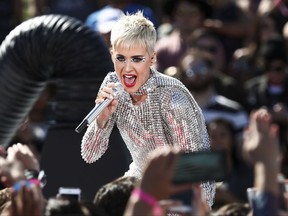 FILE - In this Monday, June 12, 2017, file photo, Katy Perry performs during 'Katy Perry - Witness World Wide' exclusive YouTube Livestream Concert at Ramon C. Cortines School of Visual and Performing Arts in Los Angeles. The pop star's "Witness: The Tour" is pushing back the start of her new tour to Sept. 19 in Montreal. Perry said in a statement Thursday, Aug. 17, that "major elements of my tour stage design could not be available for me to rehearse on until this week." (Photo by John Salangsang/Invision/AP, File)