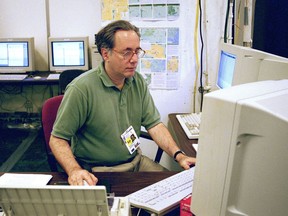 In this July 28, 1996 photo, Associated Press senior photo editor Michael Feldman works at the Summer Olympics in Atlanta. Feldman, a veteran wire service photographer and editor whose 40-year career took him from the gritty streets of Philadelphia to major international sporting events like the Olympics and soccer's World Cup, has died. He was 70. (AP Photo/Chuck Zoeller)