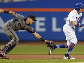 New York Mets Brandon Nimmo is tagged out by Arizona Diamondbacks third baseman Jake Lamb during the first inning of a baseball game on Monday, Aug. 21, 2017, in New York. (AP Photo/Adam Hunger)