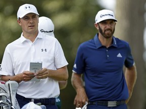 Jordan Spieth, left, and Dustin Johnson look out on the second hole from the tee box during final round play at The Northern Trust golf tournament on Sunday, Aug. 27, 2017, in Old Westbury, N.Y. (AP Photo/Adam Hunger)