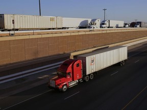 FILE - In this Monday, Nov. 21, 2016, file photo, trucks move along Interstate 35, in Laredo, Texas. U.S. President Donald Trump's campaign promise to abandon the North American Free Trade Agreement helped win over Rust Belt voters who felt left behind by globalization. But the idea is unnerving to many people in cities on the U.S.-Mexico border, like Laredo. Five days of talks aimed at overhauling NAFTA begin Wednesday, Aug. 16, 2017, in Washington, with negotiations to follow in Mexico and Canada. (AP Photo/Eric Gay, File)