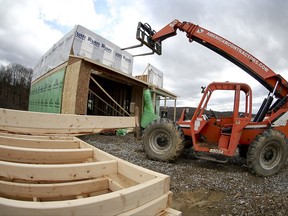 In this Wednesday, March 1, 2017, photo, a forklift is parked in front of one of the houses under construction in a housing plan in Zelienople, Pa. On Wednesday, Aug. 16, 2017, the Commerce Department reports on U.S. home construction in July. (AP Photo/Keith Srakocic)