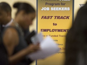 FILE - In this May 30, 2013, file photo, job seekers line up to talk to recruiters during a job fair held in Atlanta. On Thursday, Aug. 17, 2017, the Labor Department reports on the number of people who applied for unemployment benefits a week earlier. (AP Photo/John Amis, File)