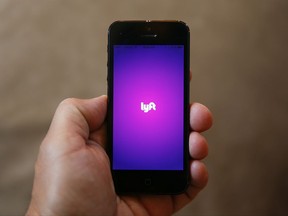 FILE - This Monday, May 16, 2016, file photo shows a smartphone displaying the Lyft app, in Detroit. On Thursday, Aug. 31, 2017, Lyft announced that it is offering service to passengers in every corner of 32 U.S. states, including hard-to-reach rural areas. The move boosts the number of states with full coverage to 40. (AP Photo/Paul Sancya, File)