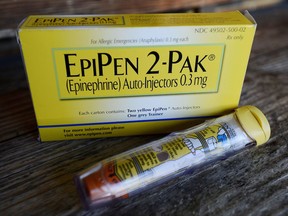 FILE - This Oct. 10, 2013, file photo, shows an EpiPen epinephrine auto-injector, a Mylan product, in Hendersonville, Texas. Mylan has finalized a $465 million federal agreement settling allegations it overbilled Medicaid for its emergency allergy injectors for a decade, charges brought after rival Sanofi filed a whistleblower lawsuit and tipped off the government. (AP Photo/Mark Zaleski, File)