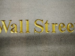 FILE - In this Oct. 8, 2014, file photo, a Wall Street address is carved in the side of a building in New York. Stocks are opening modestly higher on Wall Street, Friday, Aug. 11, 2017, led by gains in technology companies and banks. (AP Photo/Mark Lennihan, File)