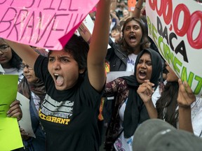 Activists supporting Deferred Action for Childhood Arrivals (DACA) cheer as they gather near Trump Tower in New York, Tuesday, Aug. 15, 2017, as they protest President Donald Trump. (AP Photo/Craig Ruttle)
