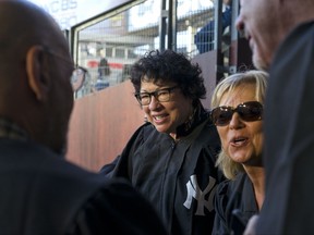 U.S. Supreme Court Justice Sonia Sotomayor, center, stands with family and friends just before the Boston Red Sox played the New York Yankees during a baseball game Thursday, Aug. 31, 2017, in New York. (AP Photo/Craig Ruttle)