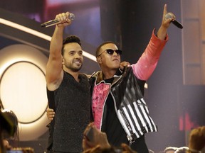 FILE - This April 27, 2017 file photo shows singers Luis Fonsi, left, and Daddy Yankee during the Latin Billboard Awards in Coral Gables, Fla. The success of their hit song "Despacito," has stretched beyond its Latin audience, becoming the year's most recognized song in the United States and other countries, and has opened doors for more Spanish tracks to be played on American radio without English lyrics. (AP Photo/Lynne Sladky, File)