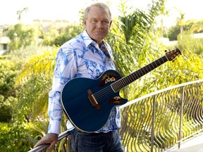FILE - In this July 27, 2011 photo, musician Glen Campbell poses for a portrait in Malibu, Calif. Campbell, the grinning, high-pitched entertainer who had such hits as "Rhinestone Cowboy" and spanned country, pop, television and movies, died Tuesday, Aug. 8, 2017. He was 81. Campbell announced in June 2011 that he had been diagnosed with Alzheimer's disease. (AP Photo/Matt Sayles, File)
