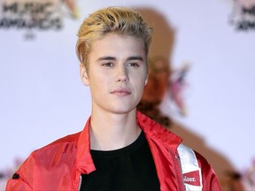 FILE - In this Nov. 7, 2015 file photo, Justin Bieber arrives at the Cannes festival palace in Cannes, southeastern France. Beverly Hills police said Thursday, Aug. 3, 2017, that Bieber will not face any criminal penalties after he accidentally struck a paparazzo with his pickup truck after leaving an event on July 26.  They also say Bieber will not face any traffic citations. (AP Photo/Lionel Cironneau, File)