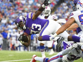 Minnesota Vikings running back Dalvin Cook (33) leaps over Buffalo Bills' Trae Elston (36) during the first half of a preseason NFL football game Thursday, Aug. 10, 2017, in Orchard Park, N.Y. (AP Photo/Rich Barnes)