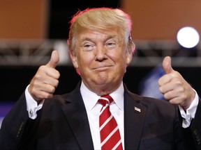 FILE - In this Aug. 22, 2017, file photo, President Donald Trump reacts before speaking at a rally at the Phoenix Convention Center in Phoenix. The Trump administration is preparing to restore the flow of surplus military equipment to local law enforcement agencies. (AP Photo/Alex Brandon, File)