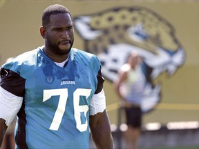 FILE - In this July 28, 2017, file photo, Jacksonville Jaguars offensive lineman Branden Albert (76) arrives at practice during NFL football training camp, in Jacksonville, Fla. A person familiar with the situation says Albert has changed his mind about retiring and asked to return to the team. The person spoke to The Associated Press on the condition of anonymity Monday, Aug. 7, because neither side has publicly discussed details about Albert's potential return. (AP Photo/John Raoux, File)