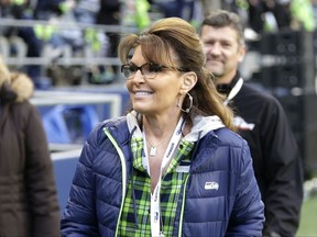 FILE- In this Dec. 15, 2016, file photo, Sarah Palin, political commentator and former Governor of Alaska, walks on the sideline before an NFL football game between the Seattle Seahawks and the Los Angeles Rams in Seattle. A federal judge on Tuesday, Aug. 29, 2017, tossed out a defamation lawsuit by Palin against The New York Times, saying the former Alaska governor failed to show the newspaper knew it was publishing false statements in an editorial before quickly correcting them. (AP Photo/Scott Eklund, File)