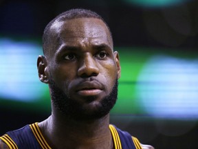 FILE- In this May 17, 2017, file photo, Cleveland Cavaliers forward LeBron James (23) looks on during Game 1 of the NBA basketball Eastern Conference finals, in Boston. James took a hard swipe at President Trump on Tuesday, Aug. 15, while calling for unity in light of the Charlottesville tragedy. Speaking on stage to students, parents and families connected his to foundation at the end of a day-long event at Cedar Point Amusement Park, James said he wanted to spend a moment addressing the weekend's violent protests in Virginia, where a woman was killed. (AP Photo/Charles Krupa, File)