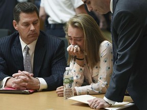 In this Friday, June 16, 2017, file photo, Michelle Carter cries while flanked by defense attorneys Joseph Cataldo, left, and Cory Madera, after being found guilty of involuntary manslaughter in the suicide of Conrad Roy III in Bristol Juvenile Court in Taunton, Mass. Juvenile Court Judge Lawrence Moniz will sentence Carter on Thursday, Aug. 3.