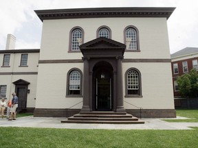 FILE - In this July 30, 2009 file photo, visitors stand outside the Touro Synagogue in Newport, R.I. The 1st U.S. Circuit Court of Appeals in Boston announced Wednesday, Aug. 2, 2017, that the nation's oldest synagogue, Shearith Israel, had won its case over the ownership of Touro Synagogue, in Newport, the nation's oldest synagogue building. The appeals court ruled that Shearith Israel owns both the synagogue building and historical Jewish ritual objects that have gone with the synagogue. (AP Photo/Eric J. Shelton, File)