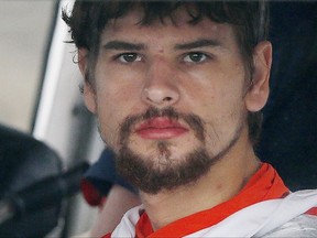 FILE - In this Sept. 27, 2016, file photo, Nathan Carman arrives in a small boat at the US Coast Guard station in Boston after spending a week at sea in a life raft before being rescued by a passing freighter. A Vermont man suspected of killing his millionaire grandfather and whose mother disappeared when they were on a fishing trip has been involved in a minor highway crash. Police say Carman was driving a pickup truck on Interstate 91 in Vernon on Monday, Aug. 7, 2017, when he was rear-ended by a tractor-trailer. (AP Photo/Michael Dwyer, File)