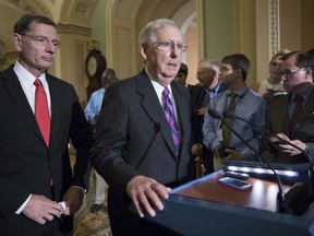 FILE- In this Aug. 1, 2017, photo, Senate Majority Leader Mitch McConnell, R-Ky., joined at left by Sen. John Barrasso, R-Wyo., holds his first news conference since the Republican health care bill collapsed last week due to opposition within the GOP ranks, on Capitol Hill, in Washington. People want President Donald Trump and congressional Republicans to try making the Obama health care law more effective, according to a national poll released Friday, Aug. 11, by the nonpartisan Kaiser Family Foundation. (AP Photo/J. Scott Applewhite, File)