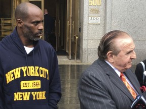FILE- In this July 14, 2017, file photo, Rapper DMX, left, leaves federal court in New York with his attorney Murray Richman after pleading not guilty to tax evasion. DMX was ordered confined to his suburban New York City home Friday, Aug. 11, by a judge who said he repeatedly violated bail conditions on tax fraud charges. (AP Photo/Tom Hays, File)