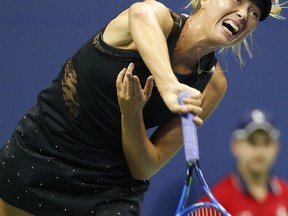 Maria Sharapova, of Russia, follows through on a serve during the opening round of the U.S. Open tennis tournament in New York, Monday, Aug. 28, 2017. (AP Photo/Kathy Willens)