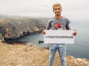 This July 18, 2017 photo shows actor Jordan Fisher at Channel Islands National Park in California as an ambassador for the National Park Service. The National Park Service is marking its 101st birthday amid a "Parks 101" campaign enlisting celebrities, actors, athletes and others to help publicize sites that get less visitation than the big parks like Yellowstone and the Grand Canyon. (Donna Irene Muccio/National Park Foundation via AP)