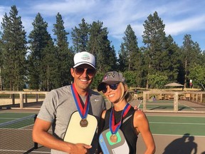 In this July 21, 2017 photo provided by Giuliana Rancic, Bill and Giuliana Rancic pose for a photo in Harrison, Idaho after winning a Mixed Doubles Pickleball Tournament. It's tempting to blow off a workout, but getting sweaty with your significant other makes a workout more fun and ups the intensity ante. (Giuliana Rancic via AP)