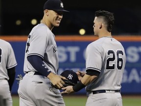 New York Yankees' Aaron Judge, left, talks to Tyler Austin, right, during the first inning of the team's baseball game against the New York Mets on Thursday, Aug. 17, 2017, in New York. (AP Photo/Frank Franklin II)