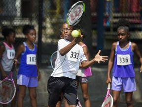 In this Tuesday, Aug. 22, 2017 photo shows Joshua Bey, 9, returning a serve during scholarship tryouts for children ages 6 to 12 who are interested in attending the John McEnroe Tennis Academy. (AP Photo/Michael Noble Jr.)