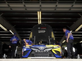 Crew members work on the car of Kyle Busch before practice for Sunday's NASCAR Cup Series auto race, Saturday, Aug. 5, 2017, in Watkins Glen, N.Y. (AP Photo/Matt Slocum)