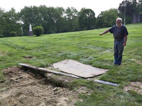 This Thursday Aug. 10, 2017 photo shows Mount Holiness Memorial Park caretaker Bill Plog as he stands by the burial plot of Cleveland Butler, in Butler, N.J. The New York Daily News reported the burial uncovered a moldering foot of a neighboring corpse that fell on top of Butler's coffin during the eulogy on Aug. 4, 2017. Plog said it's unfortunate that it happened, "but this is a graveyard." (James Keivom/The Daily News via AP)