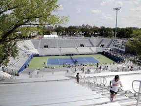 Children climb the bleachers at the temporary Louis Armstrong Stadium at the U.S. Open tennis tournament on Sunday, Aug. 27, 2017, in New York. The temporary stadium will be used while a new Louis Armstrong Stadium is built. Competition in the tournament starts on Monday. (AP Photo Peter Morgan)