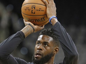 FILE - This Nov. 14, 2016 file photo shows Miami Heat forward Willie Reed (35) taking a practice shot before the start of an NBA basketball game against the San Antonio Spurs in San Antonio. Reed has been jailed in Miami on a battery charge, with officials saying it stemmed from a domestic violence incident. Reed spent last season with the Heat and had been working out in Miami in recent days. The 27-year-old center finalized a $1.5 million, one-year contract with the Los Angeles Clippers last week, despite his hopes for a longer-term, more lucrative contract in free agency. He was booked Sunday, Aug. 6, 2017. (AP Photo/Ronald Cortes, file)