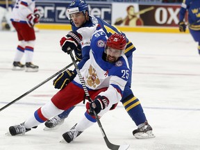 FILE - This May 24, 2014 file photo shows Russia forward Danis Zaripov, bottom, being challenged by Sweden forward Joakim Lindstrom during a semifinal match at the Ice Hockey World Championship in Minsk, Belarus. Zaripov has been cleared to pursue an NHL contract after being banned by the Kontinental Hockey League and International Ice Hockey Federation for doping. Agent Dan Milstein told The Associated Press on Monday, Aug. 28, 2017 that Zaripov was looking for a one-year deal so that he could prove himself. (AP Photo/Darko Bandic, file)