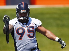 FILE - This June 5, 2017 file photo shows Denver Broncos defensive end Derek Wolfe taking part in a drill during the team's NFL football minicamp session in Englewood, Colo. The Denver Broncos' battered defensive line took another huge hit Saturday, Aug. 12, 2017 when Wolfe was carted off the field after injuring his right leg on the second snap of team drills. (AP Photo/David Zalubowski, file)