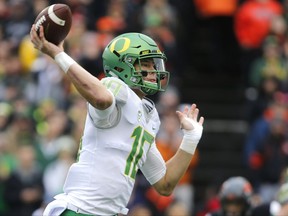 FILE - In this Nov. 26, 2016, file photo, Oregon quarterback Justin Herbert throws in the first half of an NCAA college football game against Oregon State in Corvallis, Ore. Herbert had what was essentially a two-pronged approach to the offseason: Become stronger and become a leader. Oregon opens the season at home on Saturday, Sept. 2, 2017 against Southern Utah. (AP Photo/Timothy J. Gonzalez, File)