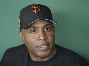 FILE - This March 22, 2017 file photo shows Barry Bonds responding to a question during a news conference in Scottsdale, Ariz. Bonds so badly wanted to play one final season in 2008 and believes he would have hit 800 home runs or come very close. It "stung" to walk away from a decorated 22-year career with little notice immediately after a record-setting season in which he became home run king with the San Francisco Giants. Bonds is over all that now, working for the Giants, and he was back at AT&T Park, Monday, Aug. 7, 2017, on the 10-year anniversary of his 756th home run here that broke Hank Aaron's record in2007. (AP Photo/Darron Cummings, file)
