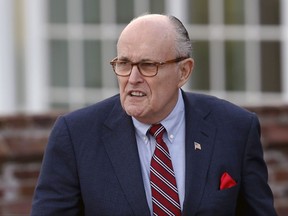 FILE - This Nov. 20, 2016 file photo shows former New York Mayor Rudy Giuliani arriving at the Trump National Golf Club Bedminster clubhouse in Bedminster, N.J. Giuliani was rushed to the hospital for emergency surgery over the weekend after falling while on vacation on Long Island on Sunday, Aug. 13, 2017. (AP Photo/Carolyn Kaster, file)