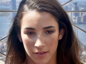 FILE - This Aug. 23, 2016 file photo shows U.S. Olympic gymnast Aly Raisman listening during an interview atop the Empire State Building in New York. Raisman, a 2012 and 2016 U.S. women's gymnastics Olympic team member, is criticizing USA Gymnastics for the way it has handled itself by overlooking sexual abuse and failing to identify alleged criminal behavior by a former national team doctor, Larry Nassar. (AP Photo/Bebeto Matthews, file)