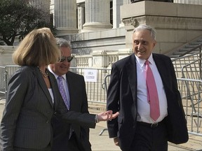 FILE- In this June 22, 2017 file photo,  Carl Paladino, right, walks with his lawyers outside the state Department of Education building in Albany, N.Y. The one-time Republican candidate for New York governor whose insults of Barack and Michelle Obama preceded calls for his ouster from the Buffalo school board has been removed from the post.  State Education Commissioner MaryEllen Elia announced her decision Thursday, Aug. 17, following a five-day hearing in June. School board members lobbied for Paladino's removal after he disclosed information about teacher contract negotiations that were discussed in closed-door sessions. (AP Photo/Mary Esch, File)