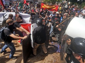 FILE - In this Aug. 12, 2017 file photo, white nationalist demonstrators clash with counter demonstrators at the entrance to Lee Park in Charlottesville, Va. Faced with an angry backlash for defending white supremacists' right to march in Charlottesville, Va., the American Civil Liberties Union is confronting a suggestion in its ranks that was once considered heresy: Maybe some speech isn't worth defending. Cracks in ACLU's strict adherence to the First Amendment's guarantee of free speech - no matter how offensive - opened from the moment a counter protester was killed in Charlottesville. (AP Photo/Steve Helber, File)