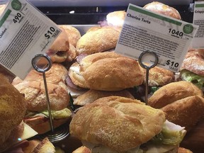 FILE - In this May 3, 2017 file photo, information cards provide calorie count and price for food items on display at a Whole Foods store, in New York. As New York City battles in court over its pioneering rules requiring some restaurants, grocery stores and other eateries to post calorie counts, scientists are trying to judge whether the city's system has achieved a goal of getting people to change bad eating habits. (AP Photo/Candice Choi, File)