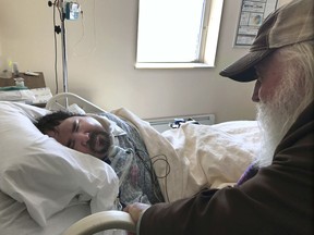 In this April 18, 2017, photo, Walter Wenger visits his severely disabled son, Steven, in a hospital in Kingston, N.Y., where he was moved after maggots were twice found in the area around his breathing tube while living in a state group home. The Associated Press obtained a confidential report on the state investigation that determined the 2016 infestations at the group home in Rome, N.Y., were the result of neglect by caregivers. In most states, details of abuse and neglect investigations in state-regulated institutions for the disabled are almost never made public. (AP Photo/David Klepper)