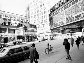 FILE - This Oct. 4, 1984 file photo shows porn shops and peep shows in New York's Times Square. New York City's two-decade legal war on storefront pornography businesses has reached a new tipping point. While many of the provocative attractions were swept out years ago - especially ones in the now neon-lit, retail-filled Times Square – the state's highest court recently issued a ruling that would force the surviving ones to clear out. (AP Photo/Mario Cabrera, File)