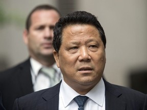 File- This July 27, 2017, file photo shows Ng Lap Seng leaving federal court in Manhattan. A judge tightened security Monday, Aug. 7, 2017, at the luxury Manhattan apartment where Ng will likely reside under 24-hour guard until sentencing. (AP Photo/Mary Altaffer, File)