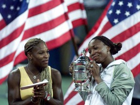 File-This Sept. 8, 2001, file photo shows Venus Williams admiring her trophy as sister Serena, left, looks on after Venus won the final of the US Open in New York. Andy Roddick was the last American man to win a Grand Slam title, all the way back at the 2003 U.S. Open. The last American woman other than Serena Williams to collect a major trophy? That was Venus Williams, at Wimbledon in 2008. Roddick is retired, inducted into the International Tennis Hall of Fame just last month. Serena Williams is on a sabbatical, expecting her first baby sometime in the next month or so. And Venus Williams? She is still going strong at age 37, adapting to life with an energy-sapping disease well enough to have reached two Grand Slam finals in 2017, the runner-up to her younger sister at the Australian Open in January, then to Garbine Muguruza at Wimbledon last month.  (AP Photo/Richard Drew, File)